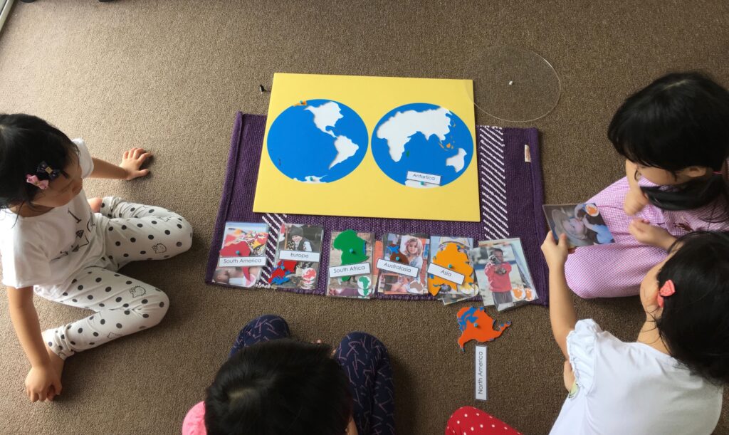 Montessori Kids Academy Learning the names of the continents and children of the World using Montessori Jigsaw Map Puzzle